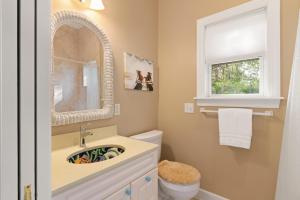 a bathroom with a sink and a mirror and a toilet at Sea Lyon Around - 1134 Park in East End +21 photos