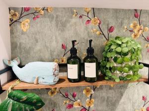 a shelf with three bottles of wine and a bird at #11 Impressive and Spacious Studio Sleeps 4 - Perfect for Contractors and Families - Free Parking in Birmingham