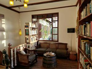a living room with a couch and a window at Greenheart Boutique Hotel in Paramaribo