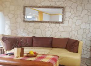a living room with a couch and a mirror at Ferienhaus am Traumpfad in Hatzenport +11 photos