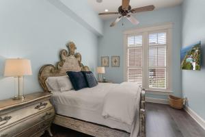 a bedroom with a bed and a ceiling fan at Sea-Esta - 1136 Postell in East End