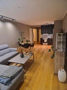 a living room with a couch and a table at Leilighet i Tromsø in Tromsø