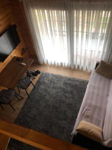 a bedroom with a bed and a desk and a television at Urla Bungalov Evleri in Urla