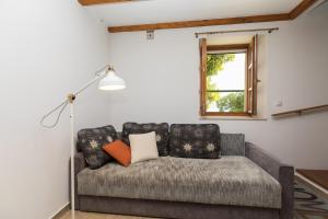 a couch in a living room with a window at Villa Nidus Onei in Omiš +56 photos