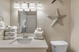 a bathroom with a sink and a starfish on the wall at Windemere 301 in Perdido Key +37 photos