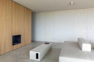 a living room with a couch and a fireplace at Beach House Stellar in Zeebrugge