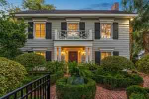 an exterior view of a house with trees and bushes at 1900 Manor and Guest House - 1900 Bruce Dr in Saint Simons Island +4 photos