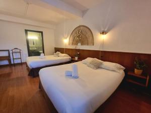a hotel room with two beds with white sheets at Hôtel Des Alliés in Pont-dʼAin