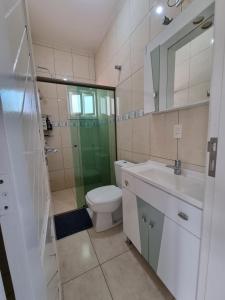 a bathroom with a toilet and a sink and a shower at Casa para 19 pessoas a 30 min Beto Carrero in Piçarras