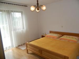 a bedroom with a bed and a large window at Vacation home Kuća za Odmor in Krasno Polje