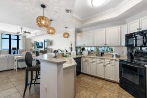 a kitchen with white cabinets and a kitchen island at Phoenix West 2005 in Orange Beach