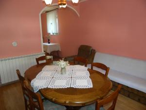 una sala da pranzo con tavolo e tovaglia bianca di Vacation home Kuća za Odmor a Krasno Polje