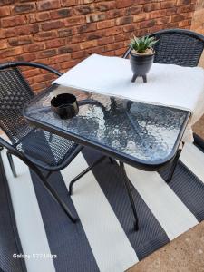a patio table with a potted plant on it at Oblique Boutique House in Centurion