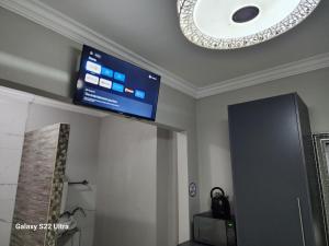 a flat screen tv on the ceiling of a room at Oblique Boutique House in Centurion