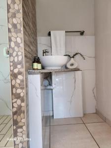 a bathroom with a sink and a toilet at Oblique Boutique House in Centurion