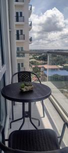 a table with a plate of food on a balcony at Cozy, spacious and well lighted condo in Iloilo City