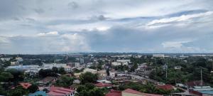 a cityscape of a city with buildings and a cloudy sky at Cozy, spacious and well lighted condo in Iloilo City +3 photos