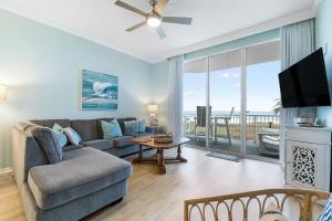 a living room with a couch and a tv at Spanish Key 105 in Perdido Key