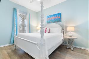 a bedroom with a white bed and a window at Spanish Key 105 in Perdido Key +40 photos