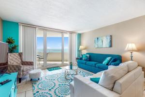 a living room with a blue couch and a blue couch at Perdido Sun 612 in Perdido Key