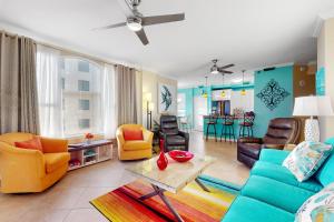 a living room with a blue couch and chairs at Beach Colony West 9D in Perdido Key