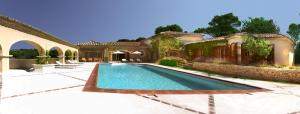 a swimming pool in front of a house at Villa Dolce Vita in Mondragon