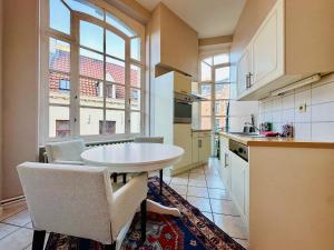 a kitchen with a table and chairs and a window at Manneken View in Brussels