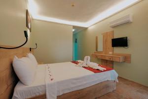 Postel nebo postele na pokoji v ubytování Tunacan Hotel