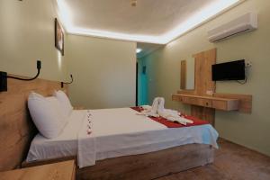 Postel nebo postele na pokoji v ubytování Tunacan Hotel