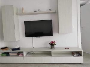 a living room with a television on a white wall at B85 Studio in Craiova