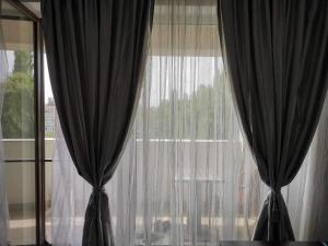 a window with black curtains in a room at B85 Studio in Craiova
