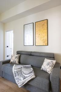 a living room with a couch and two pictures on the wall at Sendy Home Roccaraso 3 in Roccaraso