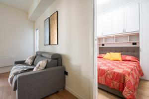 a bedroom with a bed and a couch and a mirror at Sendy Home Roccaraso 3 in Roccaraso +20 photos