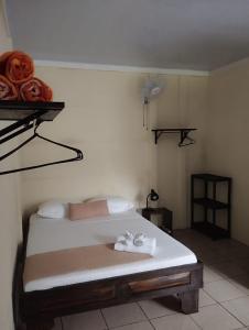 a bedroom with a bed with towels on it at Natural House in Tortuguero