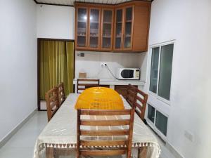 a kitchen with a table with a yellow bowl on it at Bopitiya Residence 20 Mins from Airport in Bopitiya