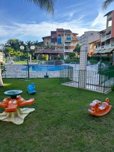 a park with a playground with some toys in the grass at Condominio Baleares,Marina Porto Itacuruca in Mangaratiba +23 photos