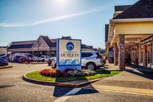 a sign for a store in a parking lot at Neptunes Grand View in Lincoln City