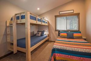 a bedroom with two bunk beds and a bed at 11 Pine Bough - Meredith Lodging in Sunriver