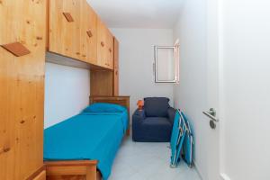 a small bedroom with a bunk bed and a chair at Soleado 9 in Santa Maria +10 photos