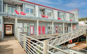 a building with red chairs on a dock at Captains Quarters - Anchor Pier Lodge in Newport +22 photos