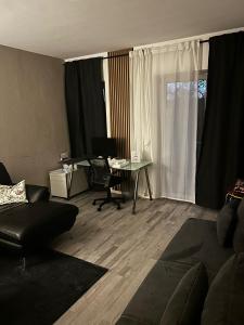 科隆Köln Wohnung 4 min nähe von Hbf und Dom mit Garten ,Balkon & office的客厅配有沙发和带电脑的书桌