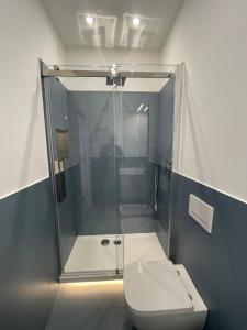 a bathroom with a glass shower and a toilet at Exclusive tra mare e centro in Genova
