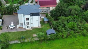 an aerial view of a white house with a roof at Jumber&Lela in Batumi