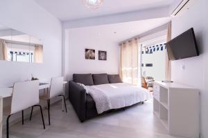 a bedroom with a bed and a desk and a television at 1st line Paseo marítimo en el puerto deportivo de Marbella in Marbella
