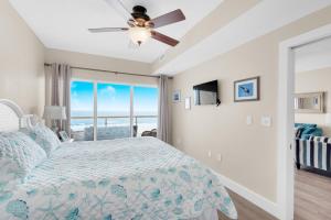 a bedroom with a bed and a ceiling fan at Emerald Isle unit 406 in Pensacola Beach +36 photos