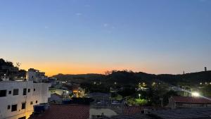 a view of a city at sunset with buildings at Cantinho do sossego Arraial do cabo - Prainha in Arraial do Cabo