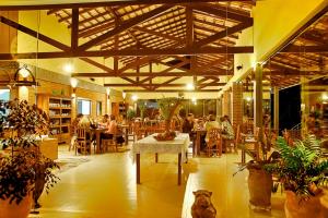 a restaurant with a cat sitting in the middle of a room at BellaMinas Pousada in Guapé