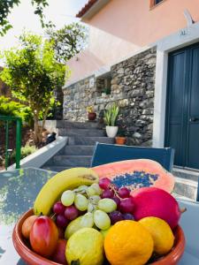 a bowl of fruit sitting on a table at Cozy House in Funchal