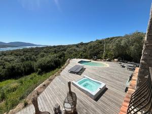 a swimming pool on top of a wooden deck at Casa Nostra in Olmeto