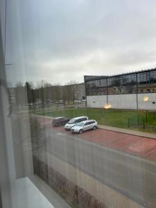 a view of two cars parked in a parking lot at Butas Radviliškio miesto centre in Radviliškis